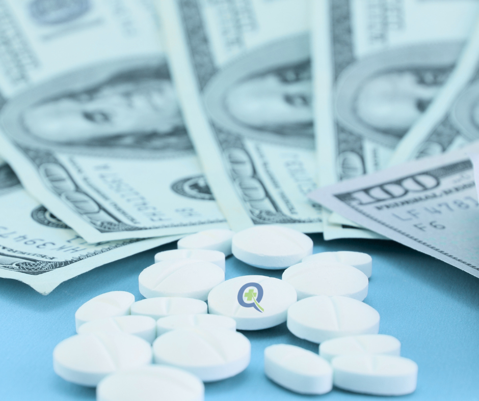 White medication pills scattered over hundred dollar bills with QuickRx logo representing C. Diff treatment costs and financial assistance