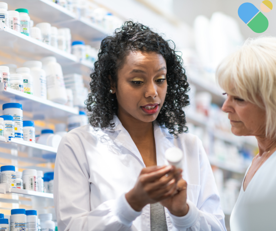 Female pharmacist explaining medication information to older female patient in pharmacy